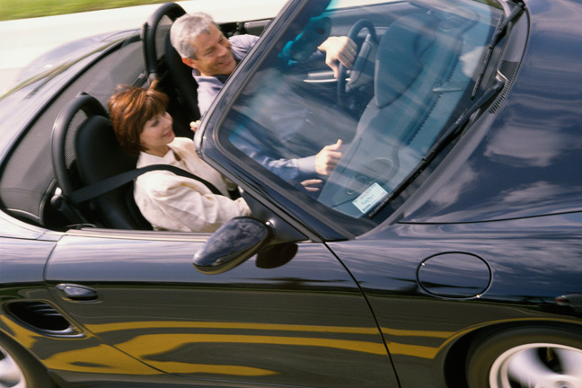 Couple sitting in a convertible car